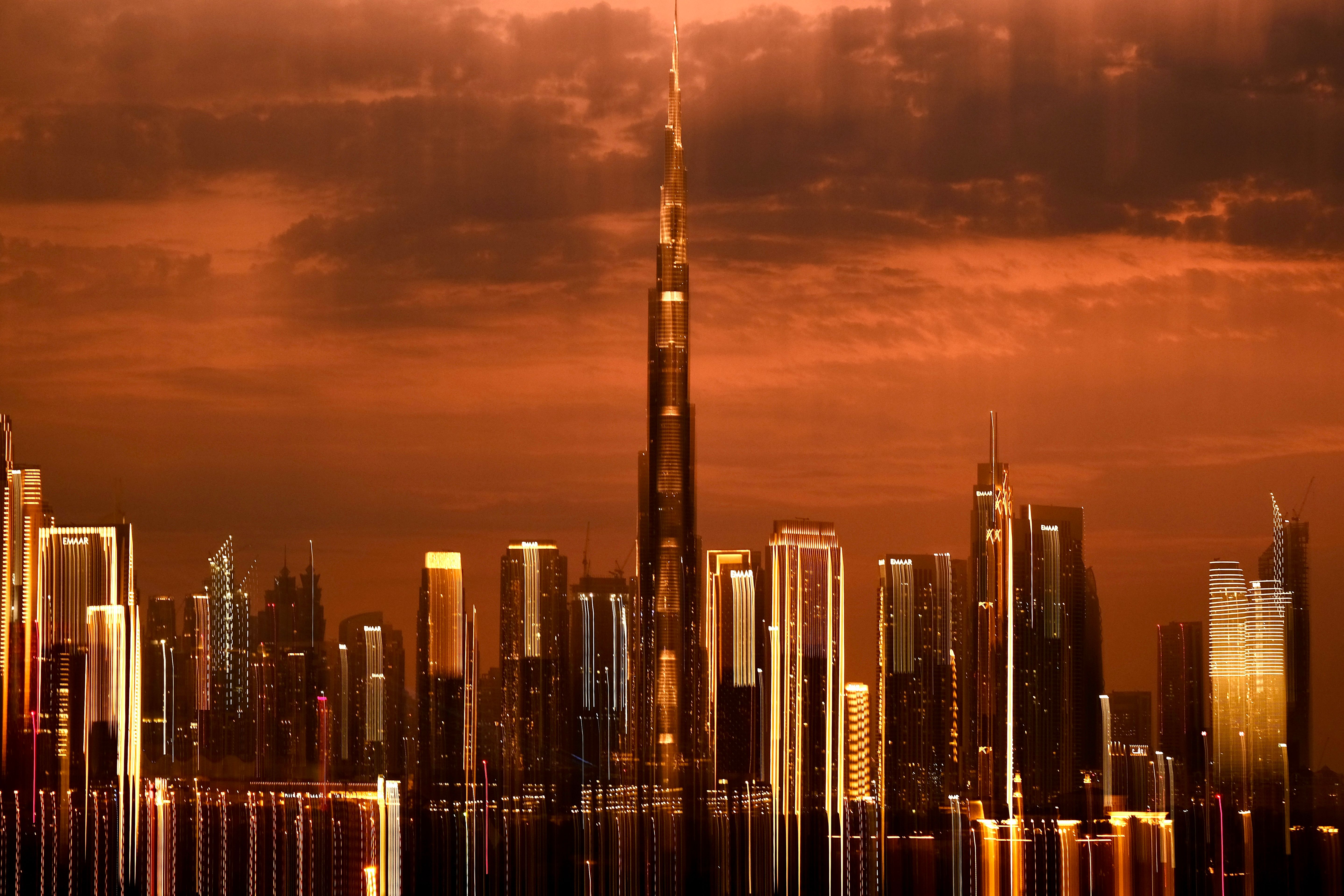 Dubai skyline with Burj Khalifa under an orange sunset sky