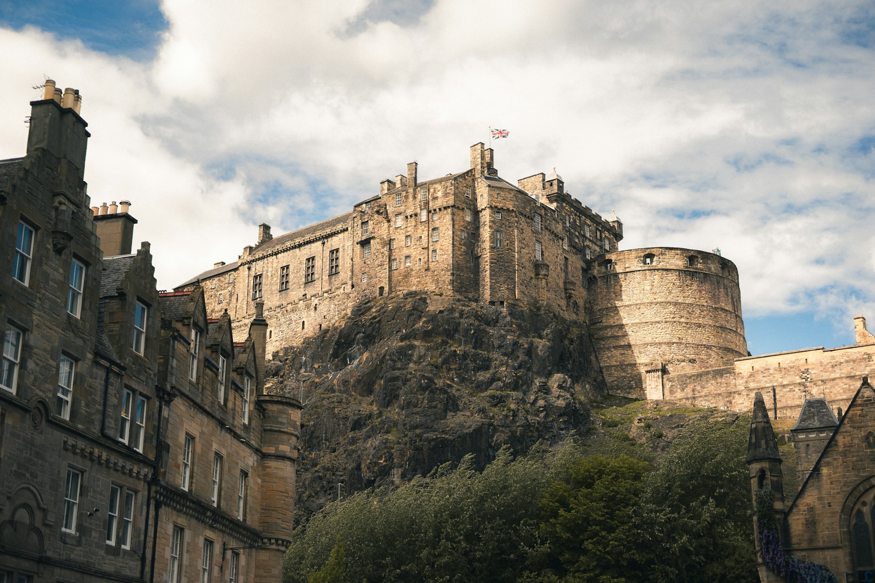 Edinburgh Castle above the rocky slope and Old Town buildings